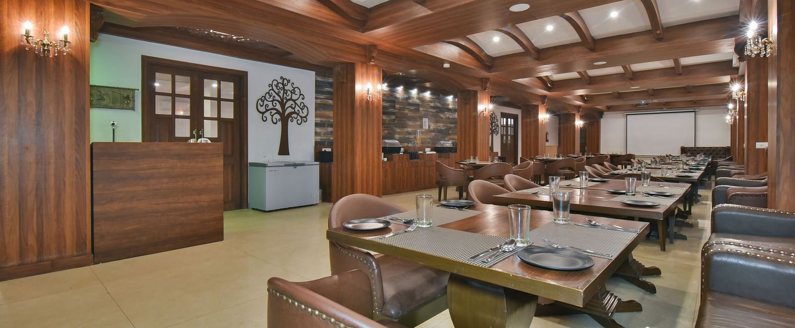 Dining seating with comfortable chairs around table at Ruttba at DLS Highland Resort and Spa, Mussoorie.