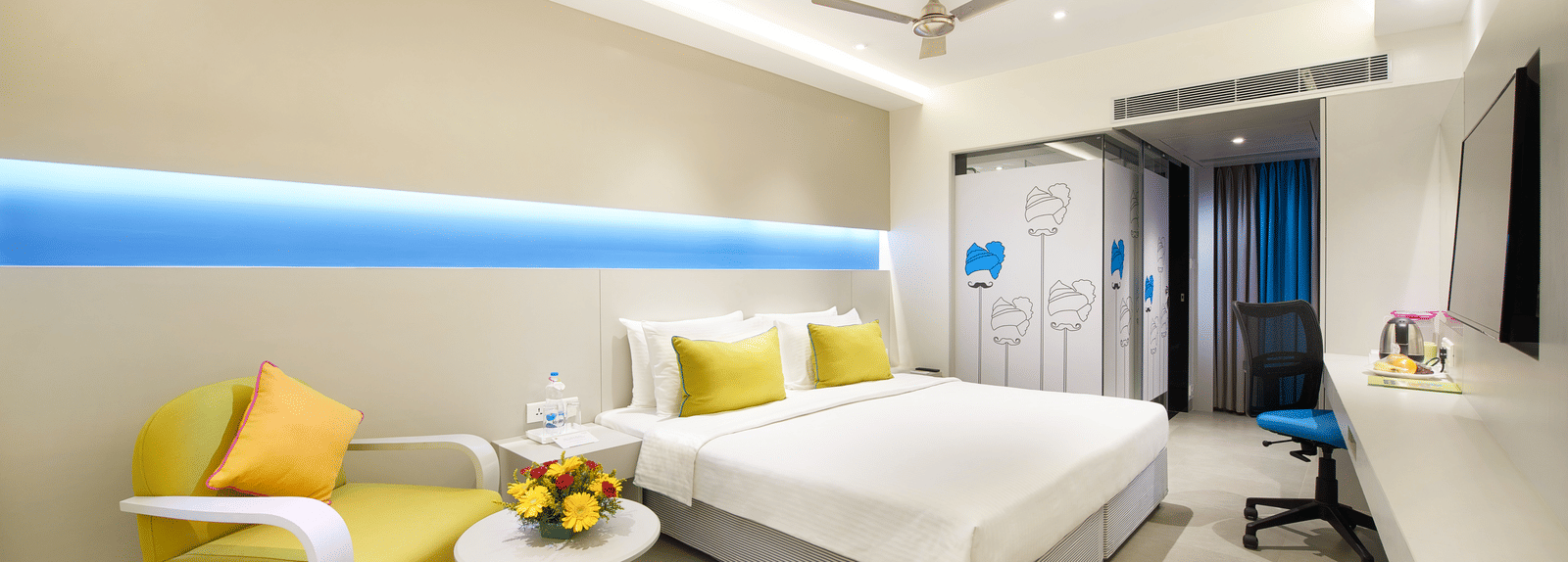 side view of a bedroom with a wall painting at  Zibe Salem by GRT Hotels