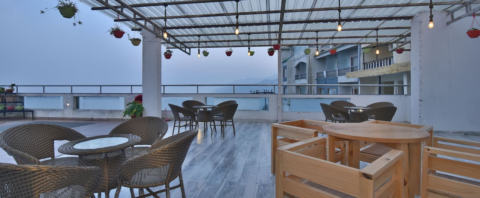 A view of the cafe with comfortable seating area at the rooftop at DLS Highland Resort and Spa, Mussoorie.
