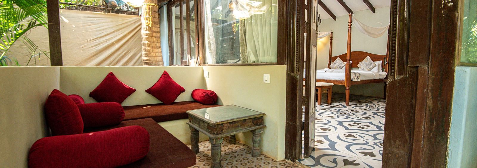 Spacious seating area with cushioned sofas and a table placed beside the sofa at De Soul Santé, Morjim.
