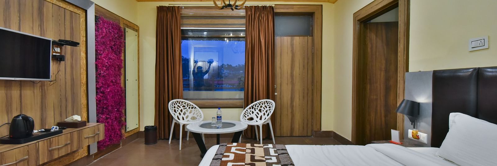 Family Suite at DLS Dalhousie Valley Resort with a  king size bed, a table, chairs and a balcony 