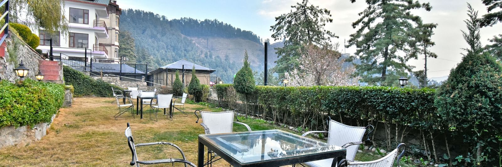 Lawn with chairs offering garden views at DLS Hillcrest Resort, Shimla.