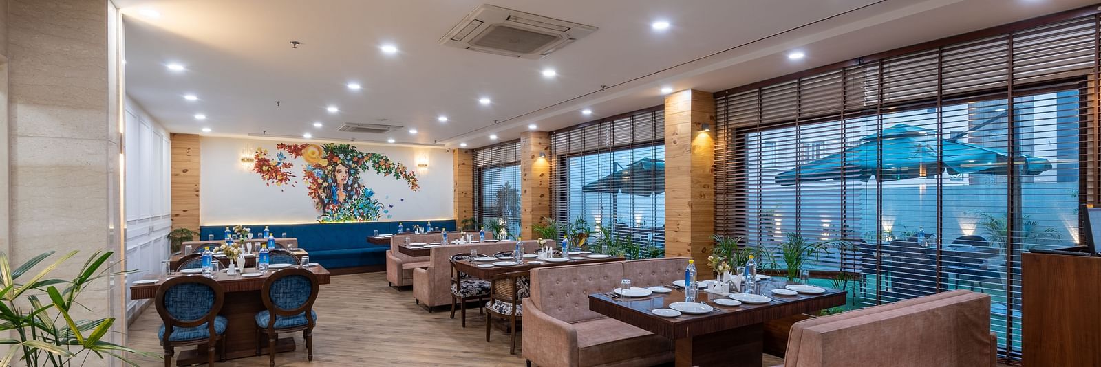 Restaurant seating area with overhead lights illuminating the space at DLS The Classio