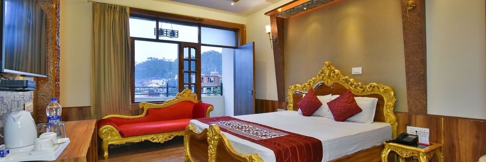 A Luxury Room at DLS Dalhousie Valley Resort with a premium bed, a sofa and balcony.