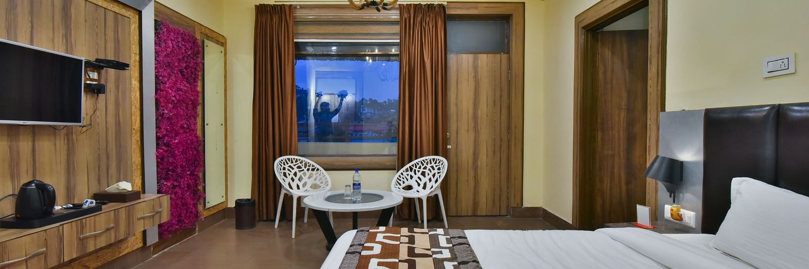 Family Suite at DLS Dalhousie Valley Resort with a  king size bed, a table, chairs and a balcony 