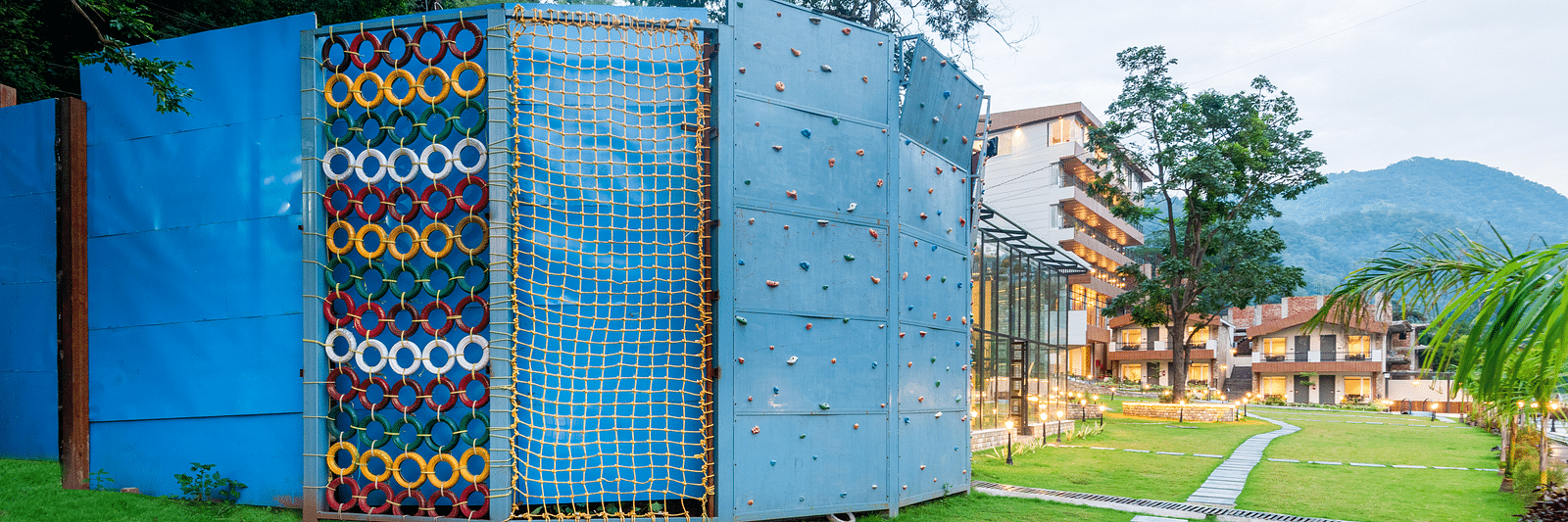 Adventure activities area in the garden of DLS Divine River Resort and Spa with rock climbing structure