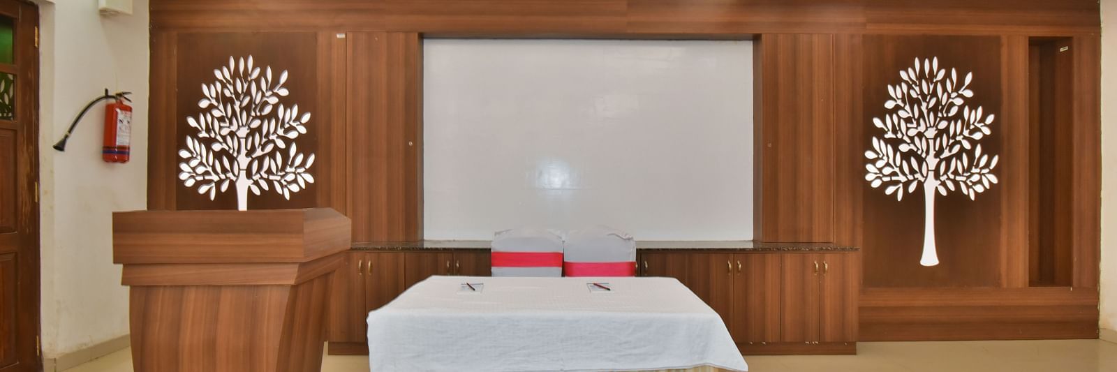 A podium next to a table at Conference Hall at DLS Highland Resort and Spa, Mussoorie.