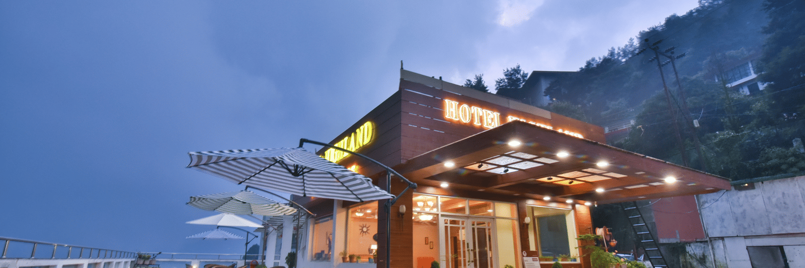 View of DLS Highland Resort and Spa, Mussoorie with comfortable seating area at the front. 