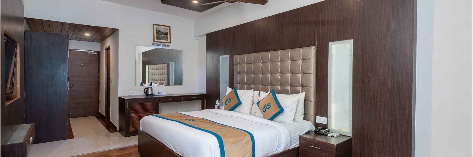 Overview of Premium Room at DLS Spring Valley Resort Dharamshala featuring a king size bed, TV and a chair