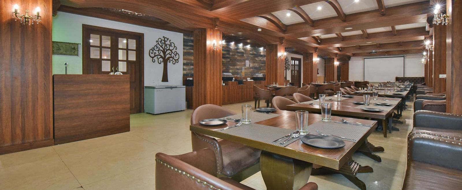Dining seating with comfortable chairs around table at Ruttba at DLS Highland Resort and Spa, Mussoorie.