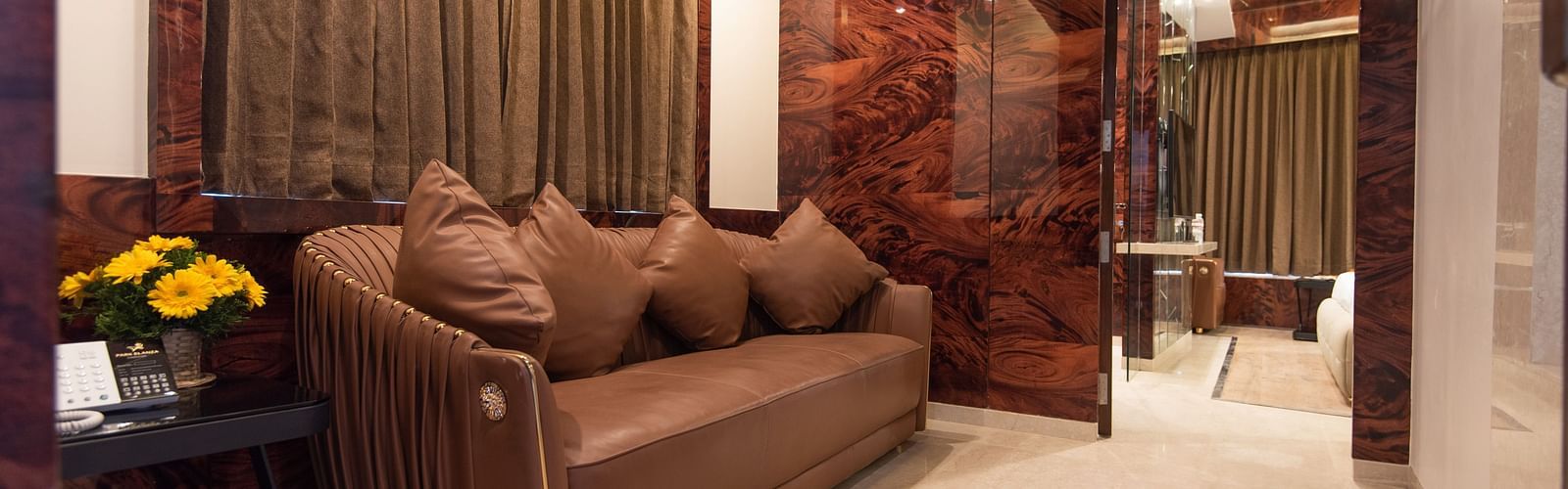 brown sofa placed in the Executive Suite at Hotel Park Elanza, Coimbatore