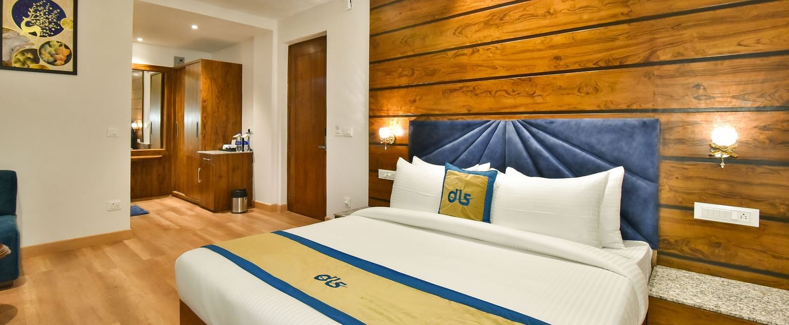 A large bed in front of the TV in Deluxe Non-view Room at DLS Ark Holiday Inn, Banikhet.