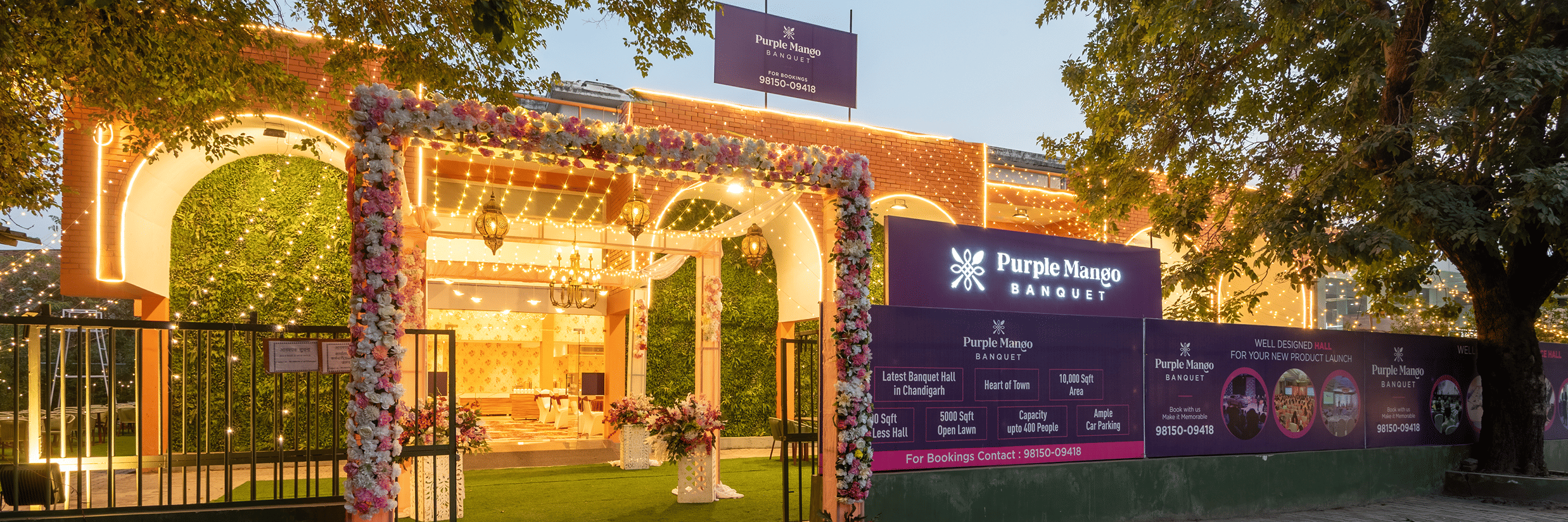 Decorated entrance archway with greenery at dusk at Mango Grove Hotel, Chandigarh.