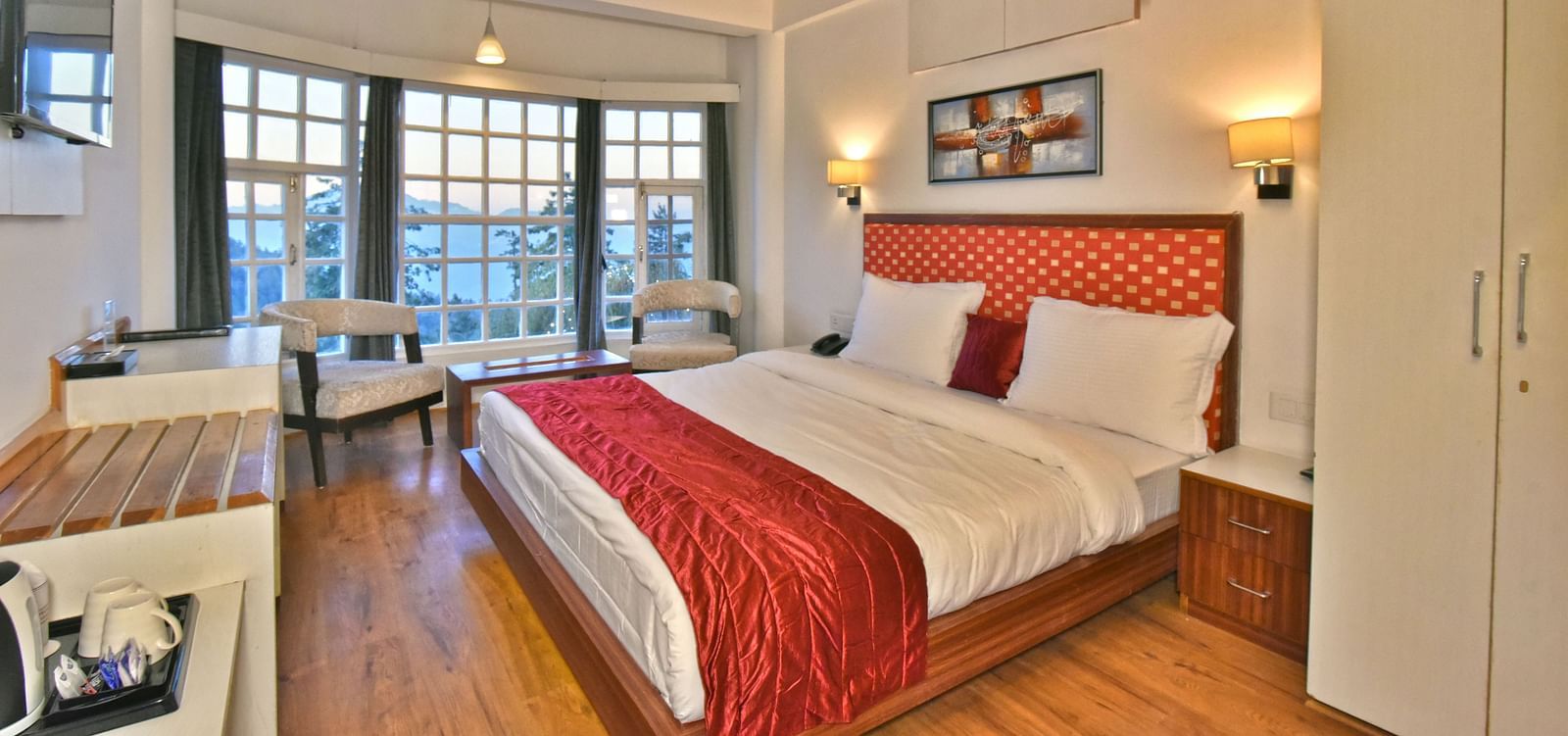Bedroom with a fancy ceiling and warm illuminating lights at DLS Hillcrest Resort, Shimla.