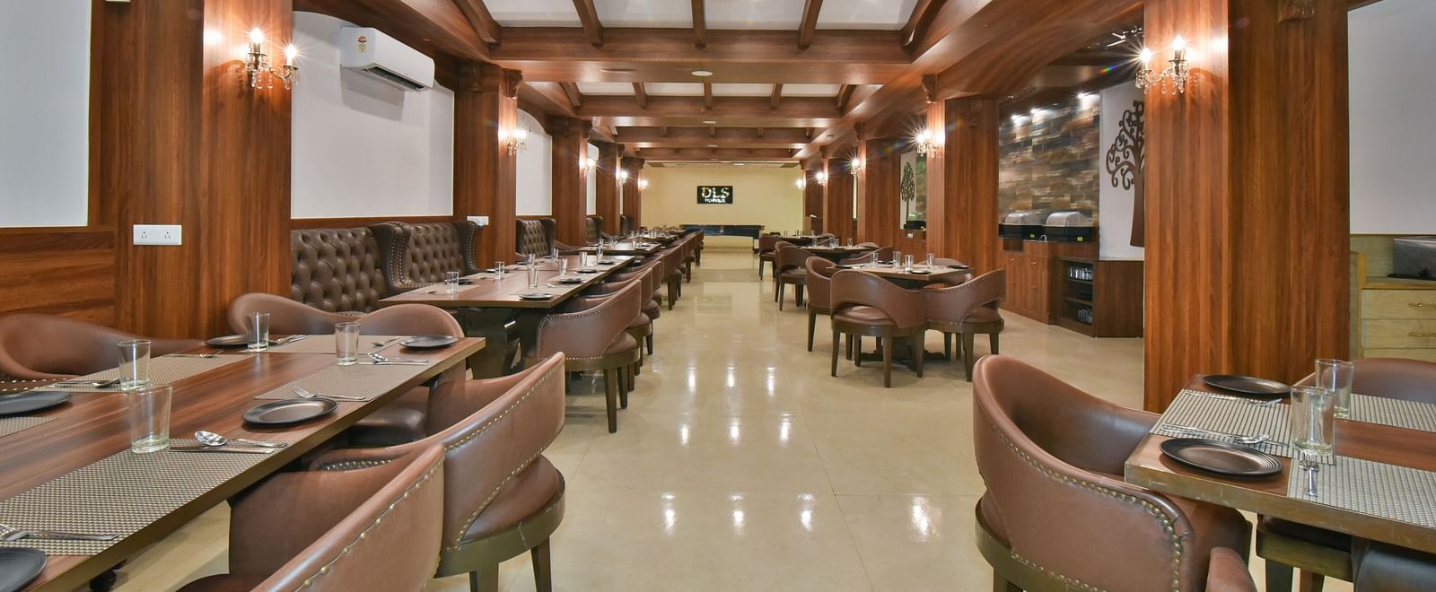 Dining seating with comfortable chairs around table at Ruttba at DLS Highland Resort and Spa, Mussoorie.