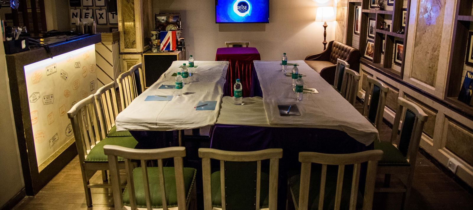 Cosy restaurant interior with a central table set for a meal under warm lighting at Oriental Aster, Mumbai.