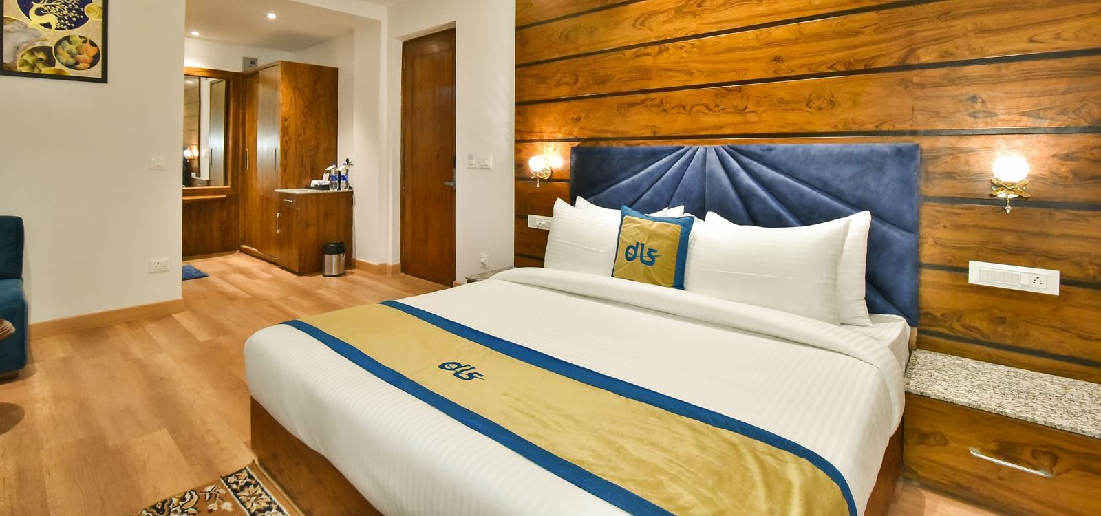 A large bed in front of the TV in Deluxe Non-view Room at DLS Ark Holiday Inn, Banikhet.