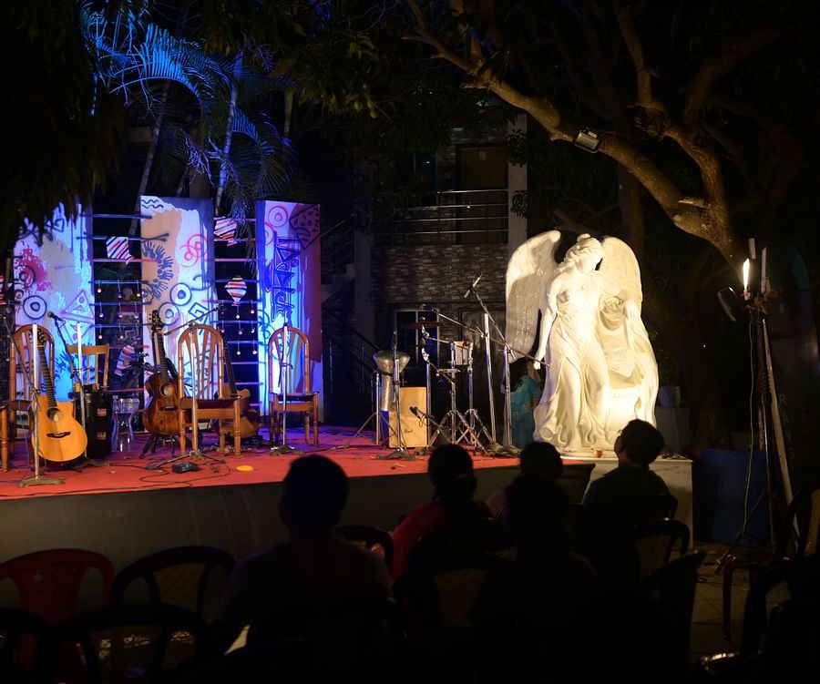 Event place at Rangamati Garden Resort featuring a stage, musical instruments, and a statue.