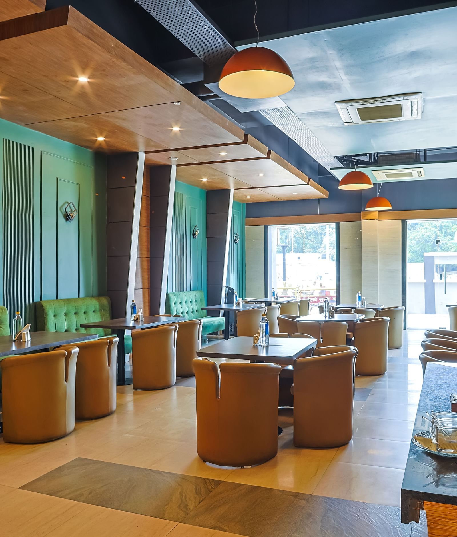 Restaurant dining area with tables, chairs and open layout at Max Hotel Prayagraj.