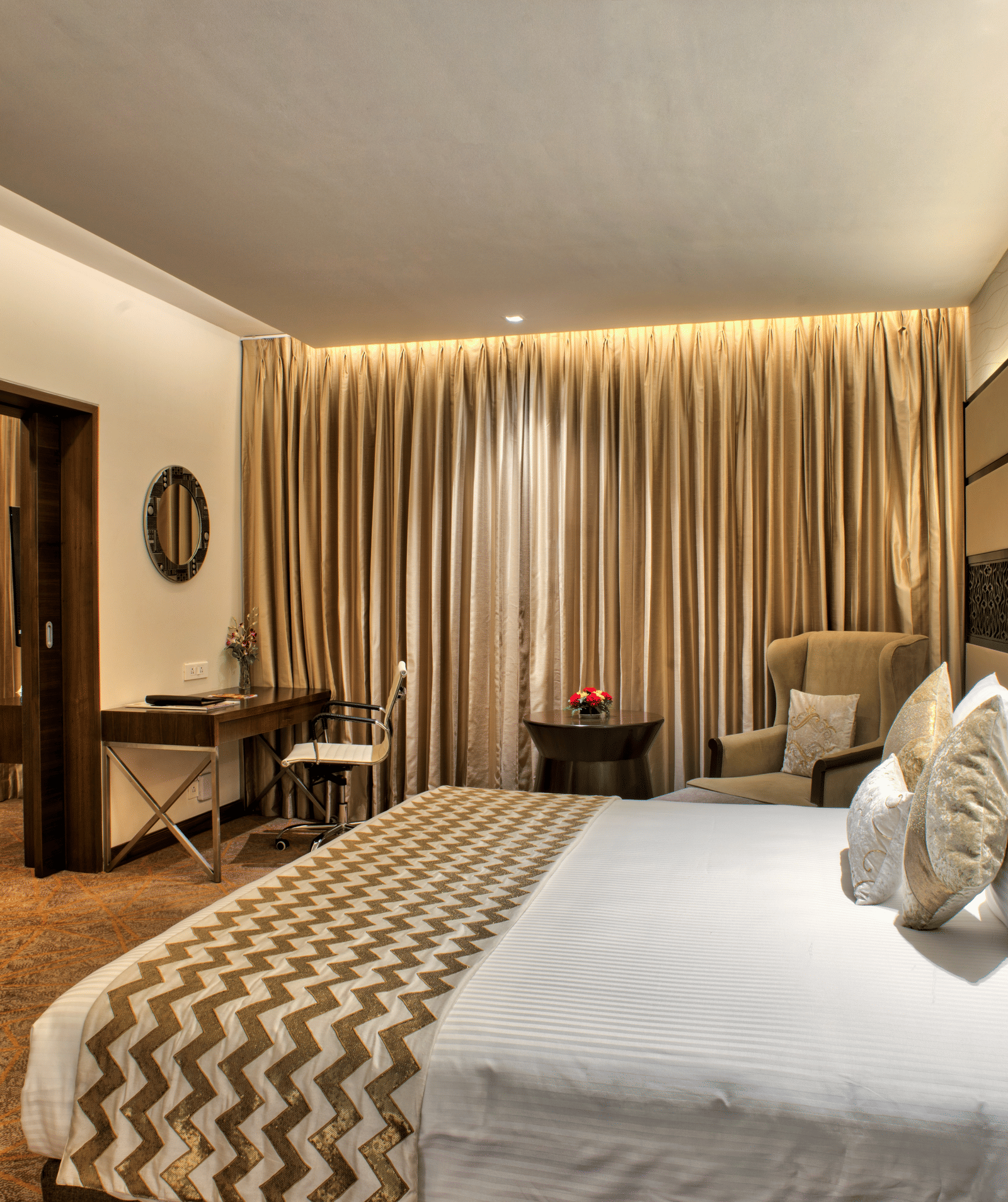 Image of the theme suite featuring a king size bed  and a seating arrangement at Grand Chennai by GRT hotels