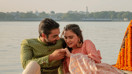 A couple in traditional attire enjoying a decorated riverside picnic on a Nauka (boat) - Polo Floatel Kolkata