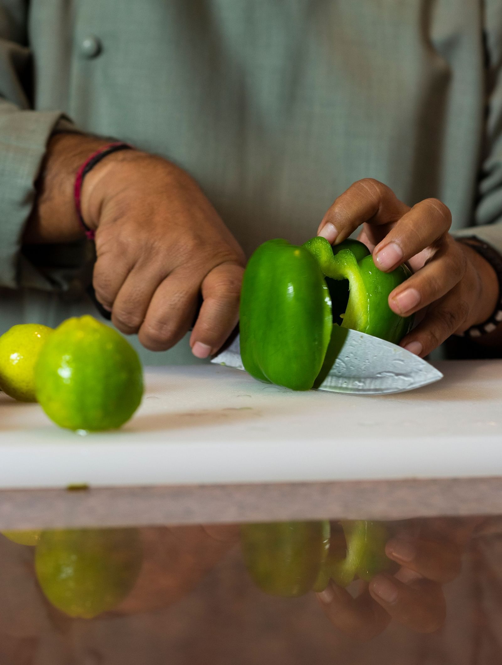 Image of a chef cutting vegetables on a chopping board.