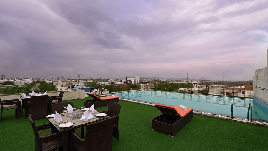 Rooftop Swimming pool with lounge chairs and a seating arrangement
