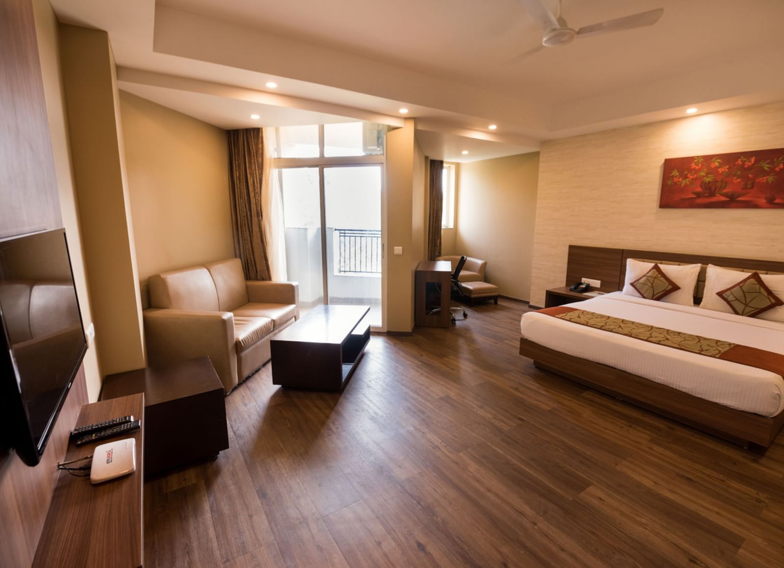 Super Deluxe Rooms with Complimentary Wi-Fi captured with a cosy bed and white linens along with a beige couch - Le ROI Digha Hotel West Bengal7