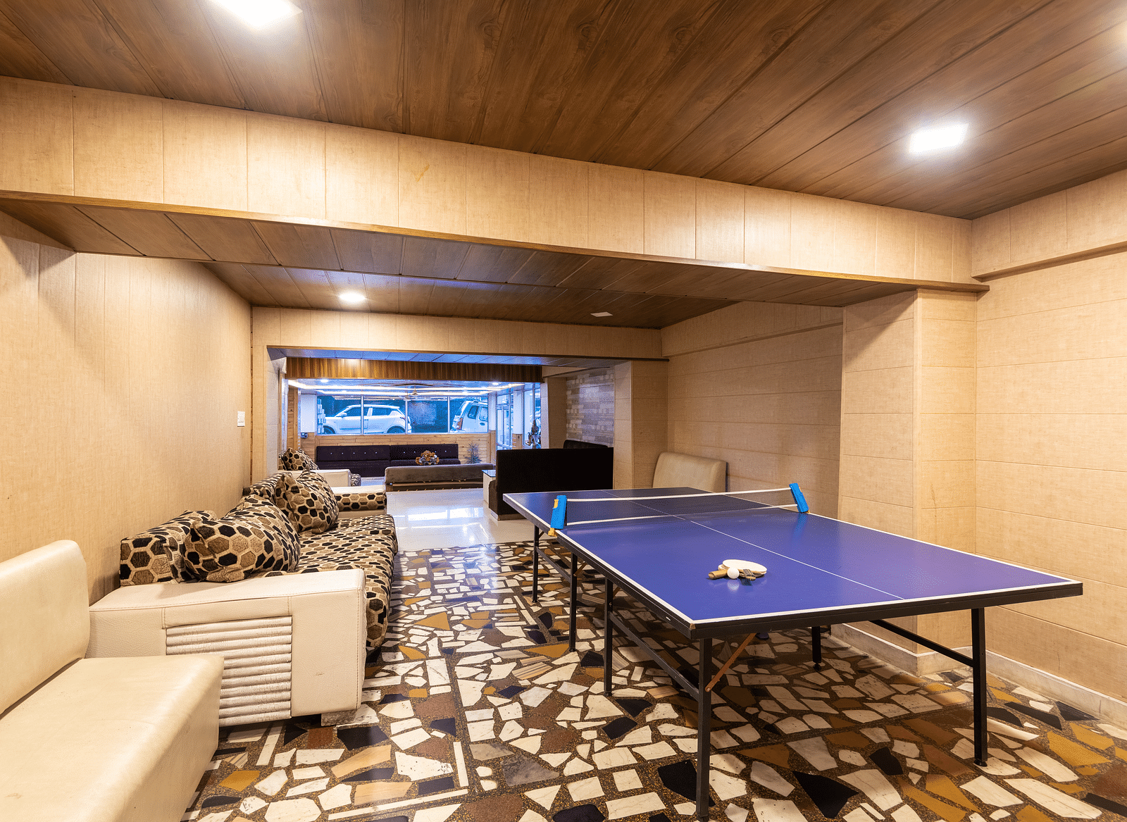 Image of a table tennis zone kept in the lobby with a white couch in the side | DLS Anupam Resort, Dharamshala
