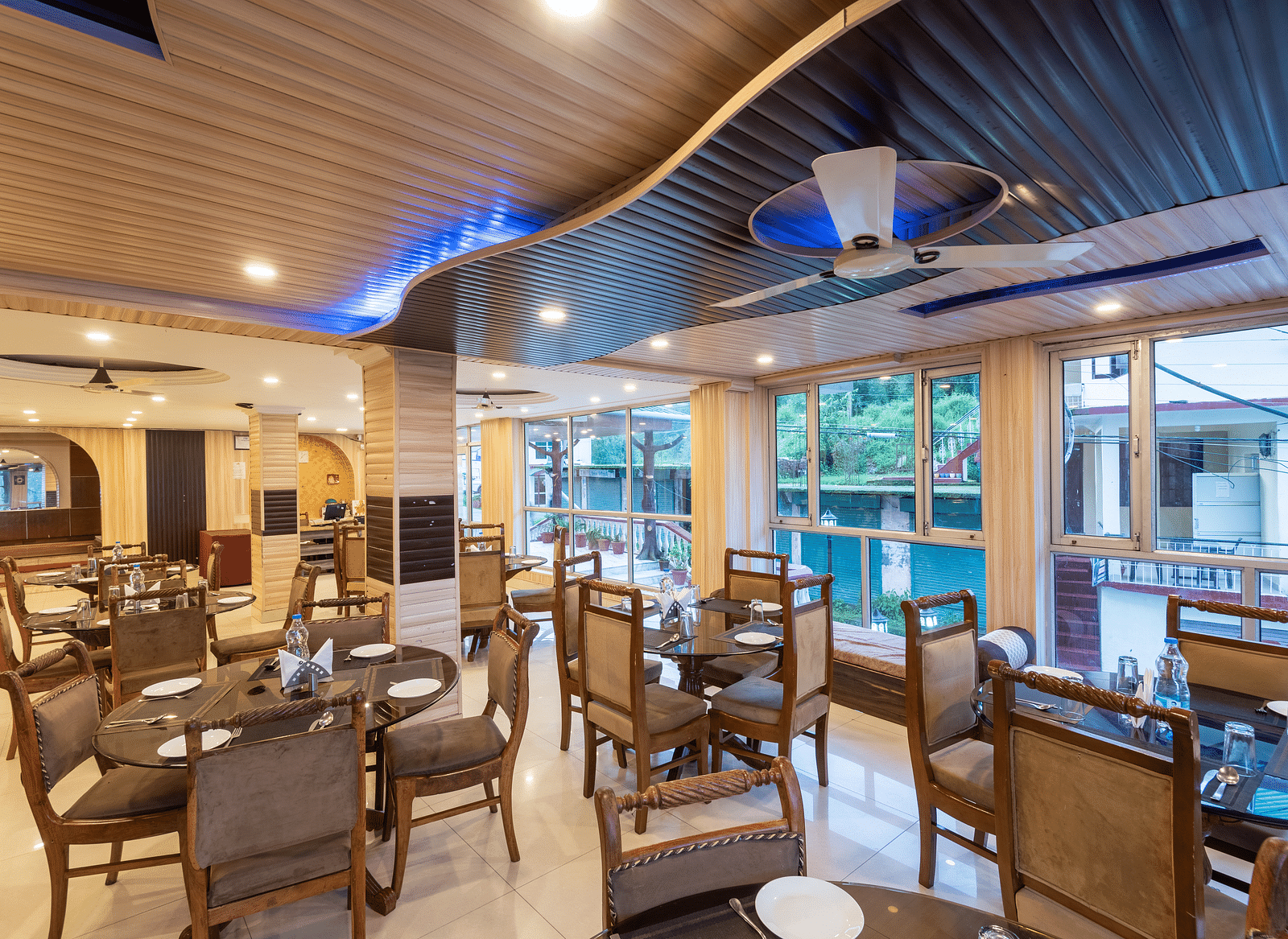 Image of the dining area featuring table and chairs | DLS Anupam Resort, Dharamshala