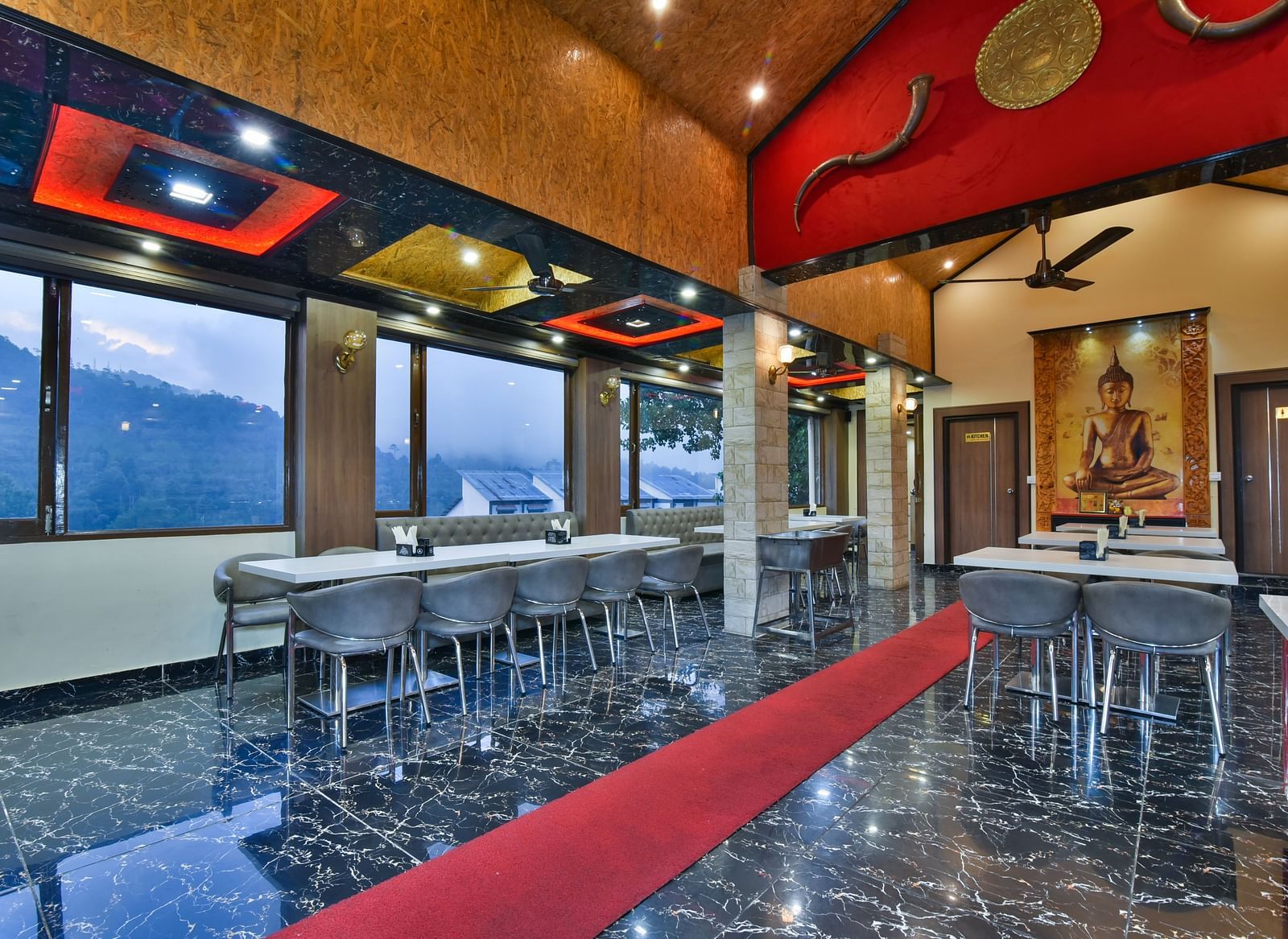 Restaurant at DLS Dalhousie Valley Resort with chairs, tables and serene views