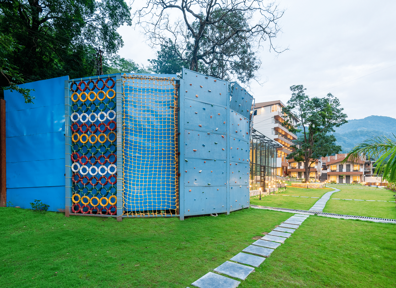 Adventure activities area in the garden of DLS Divine River Resort and Spa with rock climbing structure