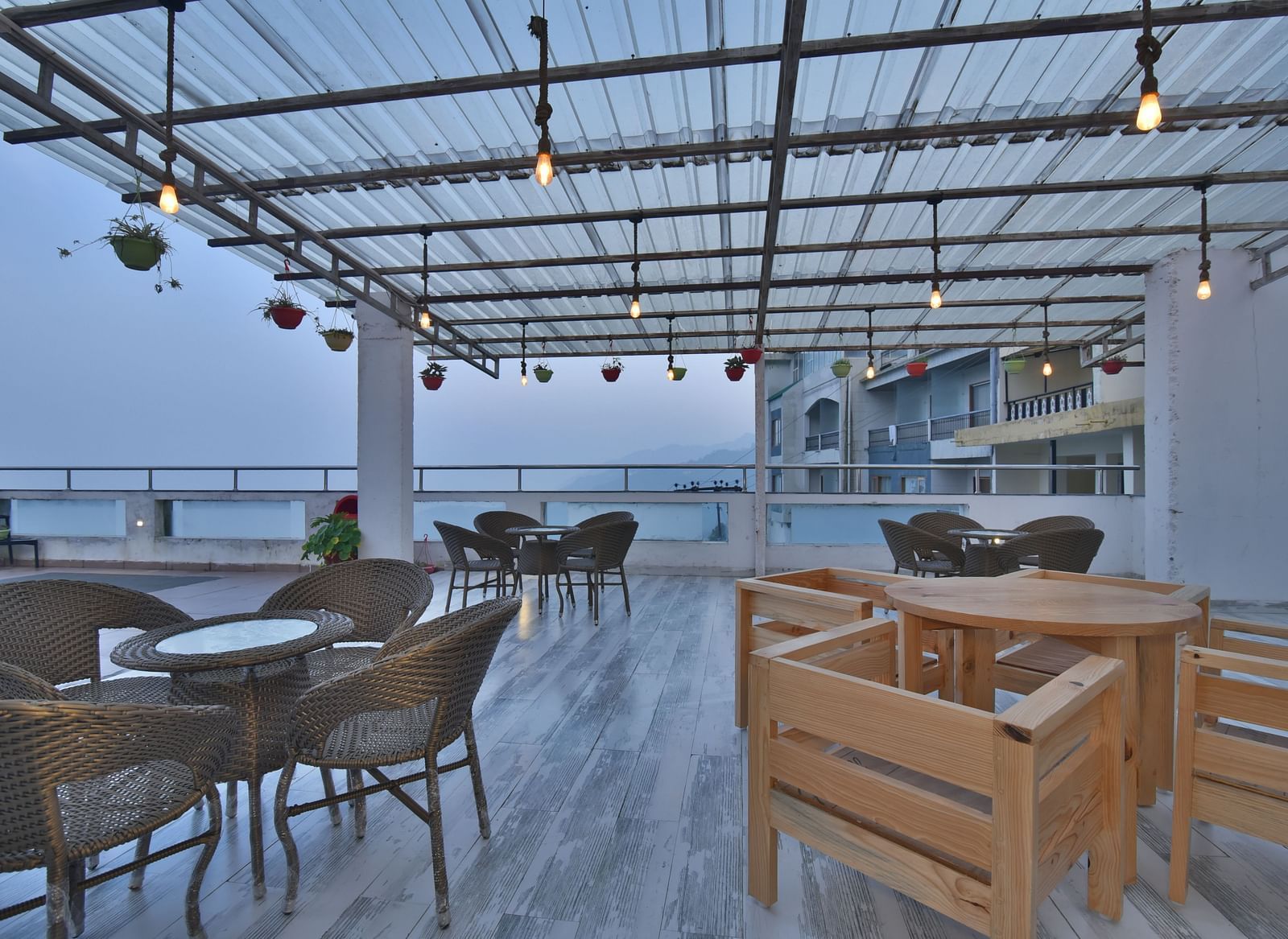 A view of the cafe with comfortable seating area at the rooftop at DLS Highland Resort and Spa, Mussoorie.