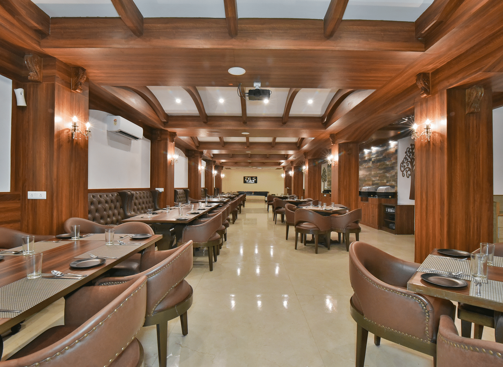 Dining seating with comfortable chairs around table at Ruttba at DLS Highland Resort and Spa, Mussoorie.