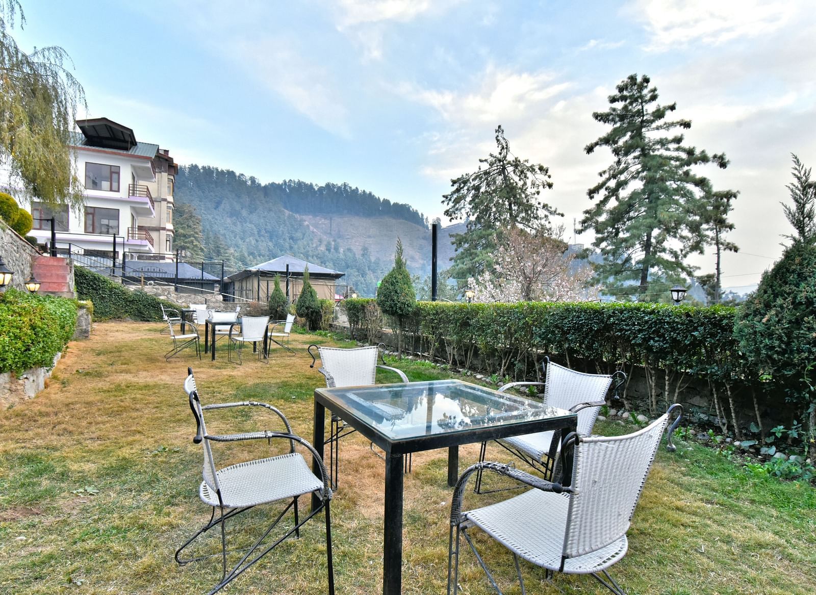 Lawn with chairs offering garden views at DLS Hillcrest Resort, Shimla.