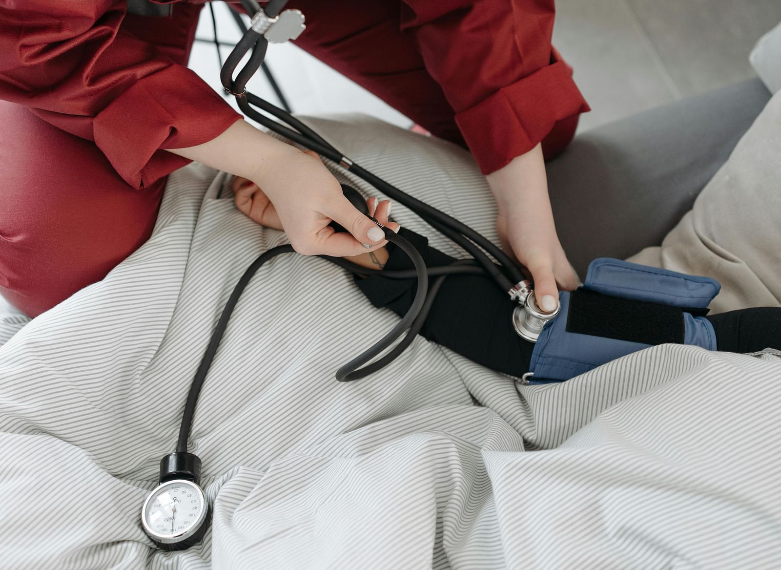 A doctor checking a patient's blood pressure