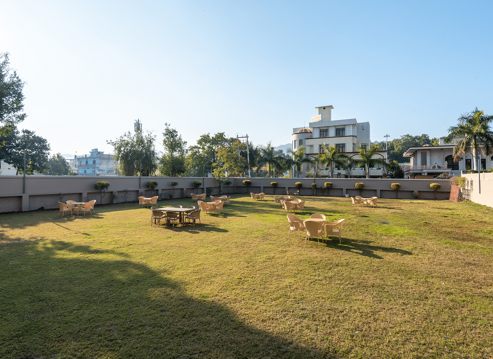 Spacious lawn area with seating arrangements at DLS Park Grace, Haridwar.