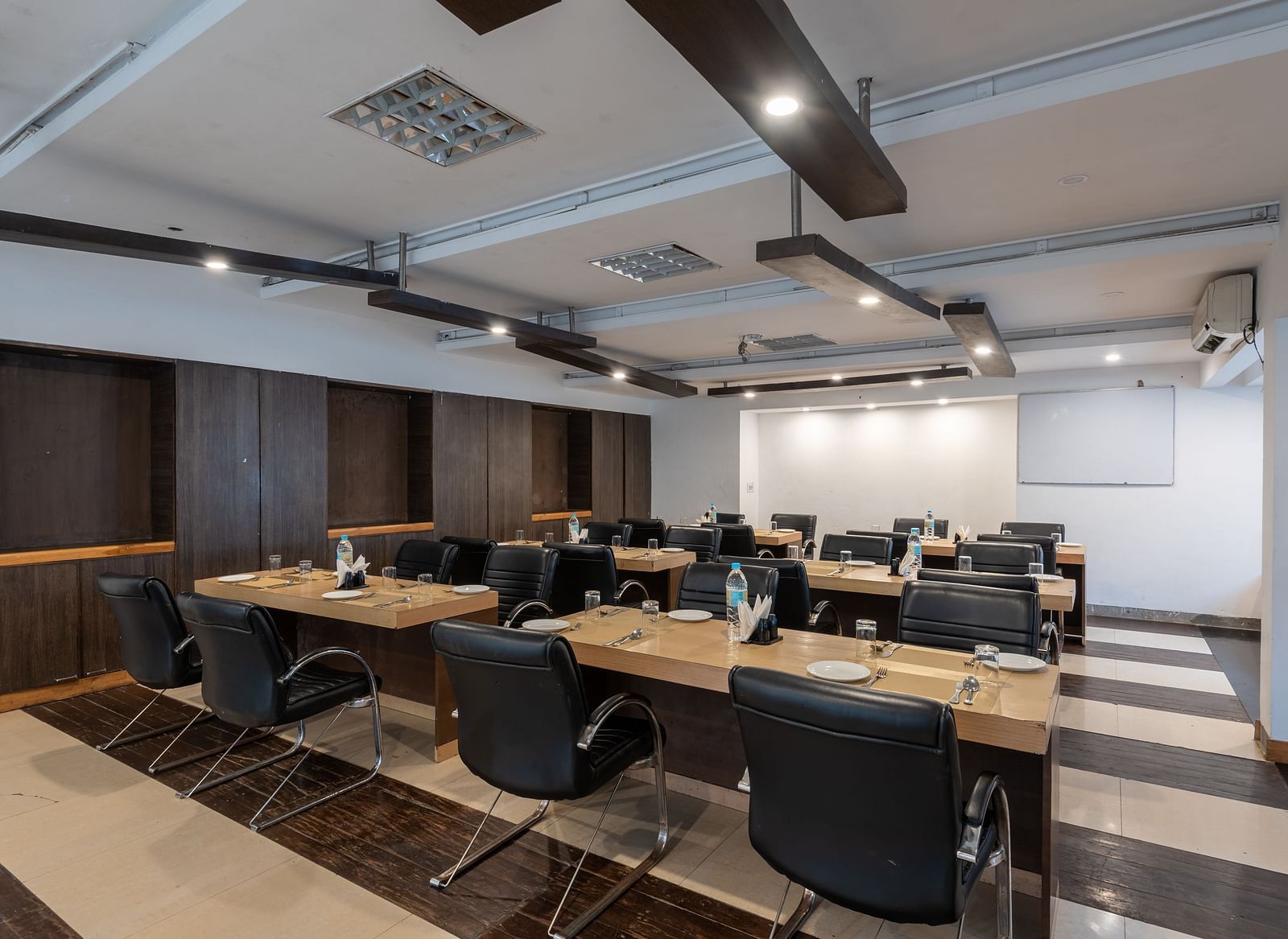 Conference Hall  at DLS Spring Valley Resort Dharamshala  with chairs and tables arranged in classroom setting 