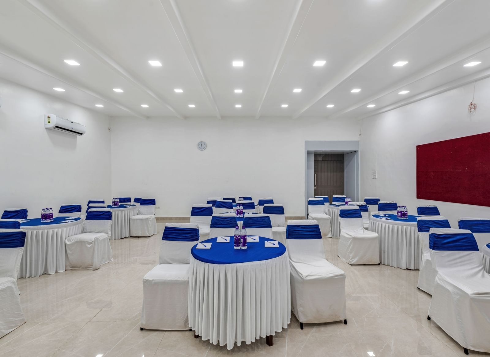 Cluster setting with round tables and blue covers at Emerald Retreat, Tungarli.