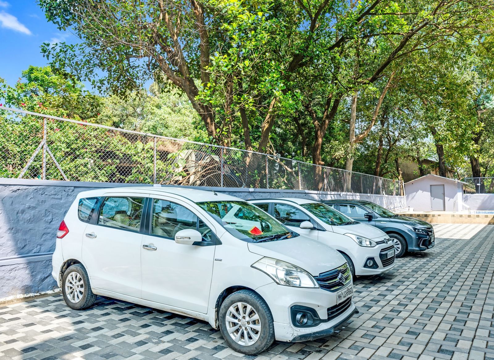 Ample on-site car parking facility with multiple cars at Emerald Retreat, Tungarli.