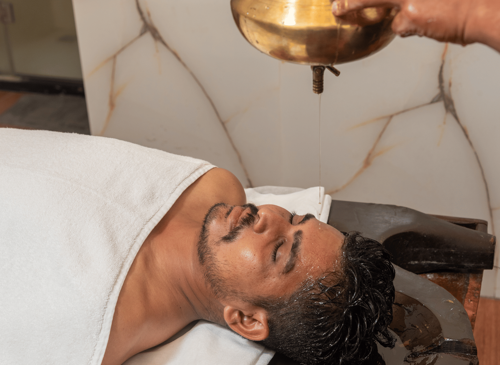 Shirodhara therapy in progress at DLS Hotels On The Ganges.