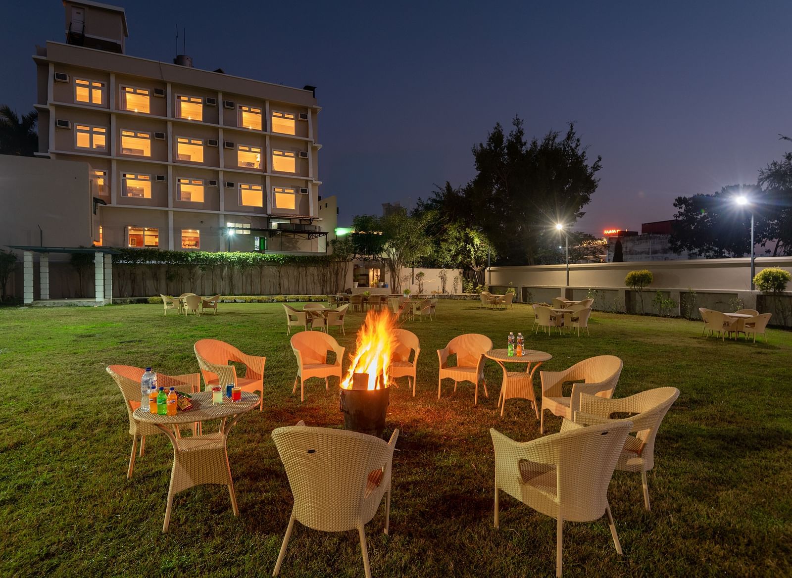 A bonfire with arranged chairs in the lawn at DLS Park Grace, Haridwar.