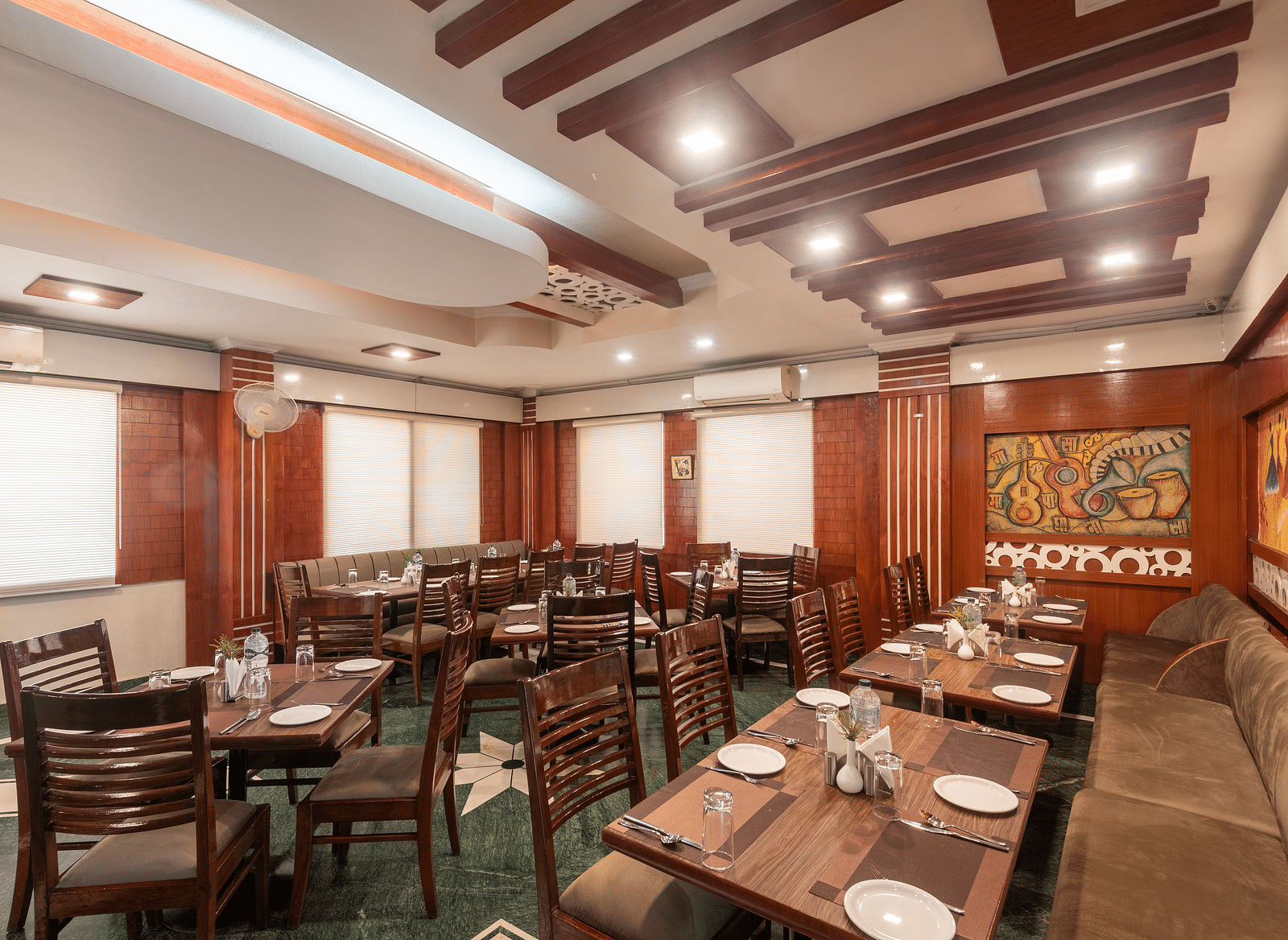 Dining area with fancy ceiling lights at DLS Park Grace, Haridwar.