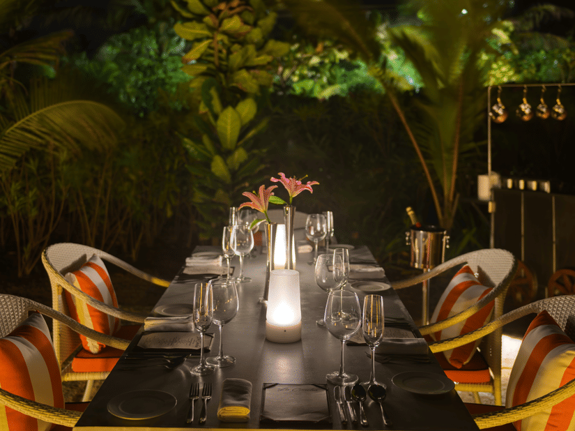 A table for 4 guests in an outdoor setting of La Concha set for a cosy intimate diner at Azaya Beach Resort, Goa.