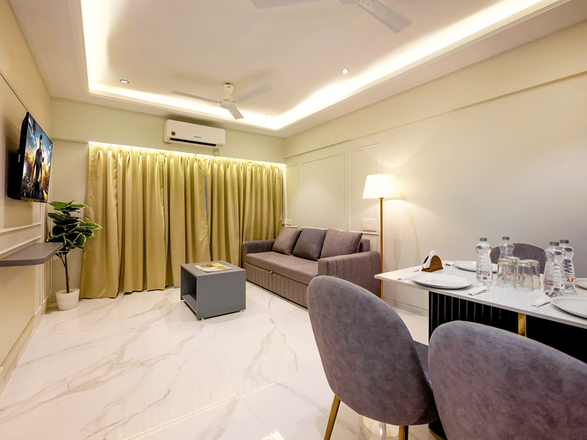 Open plan living and dining area with workspace at Home2 Residency, Mumbai Airport