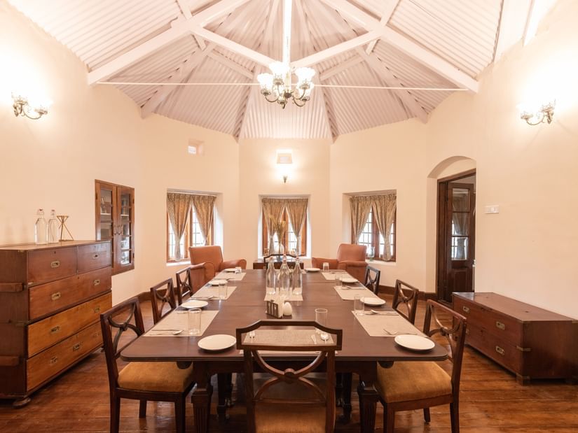 The interiors of the dining hall with a long dining table and rounded walls - Ibex Stays & Trails, Coonoor (Leewood).
