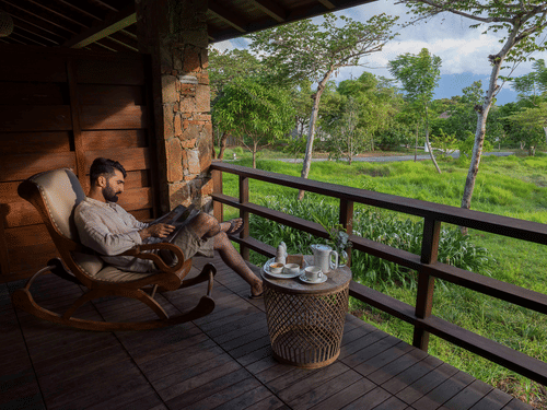 a person reading a magazine outdoors at The Serai Bandipur