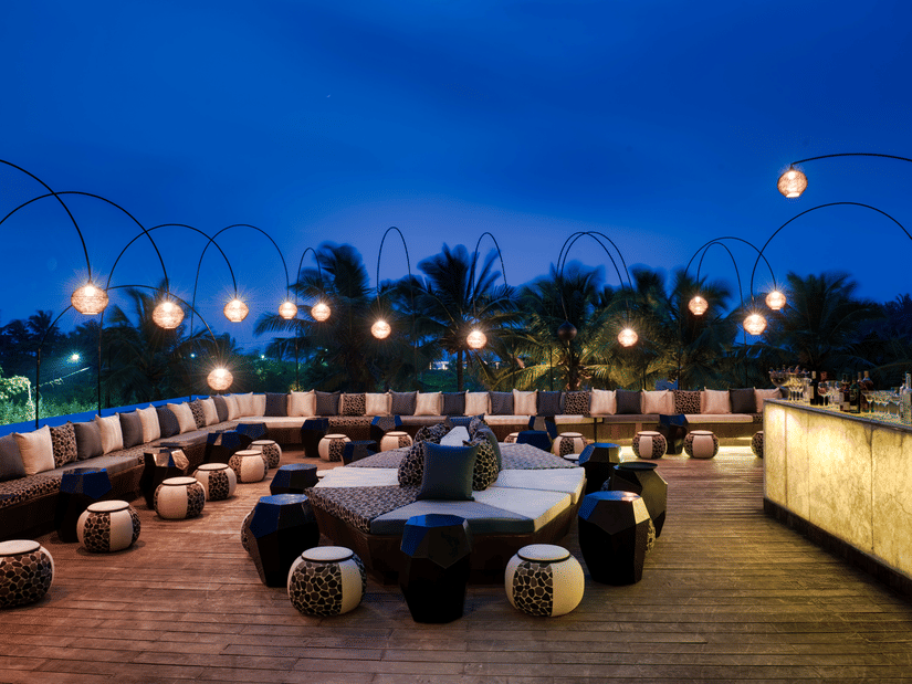Seating area at Lynx Patio with the late evening sky in the background, restaurant in south Goa - Azaya Beach Resort Goa
