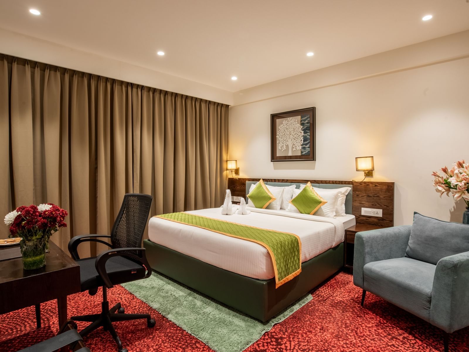 Elegant room with king size bed, seating area, and modern decor at Hotel Royal Regency Chennai