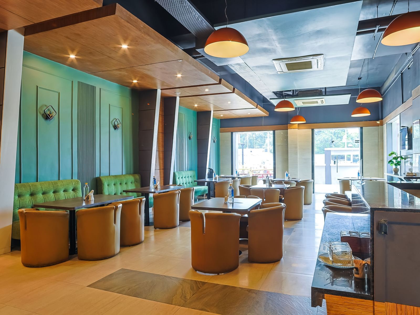 Restaurant dining area with tables, chairs and open layout at Max Hotel Prayagraj.